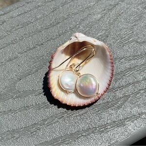 Lustrous coin pearl with gold plated fish hook post. Kamala pearls.